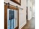 Hallway view featuring a wooden accent, hardwood floors, and natural light at 7150 Irongate Dr, Indian Land, SC 29707