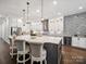 Modern kitchen island with pendant lighting, stainless steel appliances, and a stylish backsplash at 7150 Irongate Dr, Indian Land, SC 29707