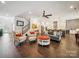 Open-concept living room flows into a modern kitchen with hardwood floors and stylish furnishings at 7150 Irongate Dr, Indian Land, SC 29707