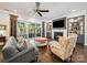 Cozy living room features a fireplace, built-in shelving, and access to an outdoor patio at 7150 Irongate Dr, Indian Land, SC 29707