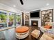 Cozy living room featuring a fireplace, built-in shelves, and access to an outdoor patio at 7150 Irongate Dr, Indian Land, SC 29707