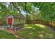 Well-maintained backyard with lush lawn, brick-lined garden beds, and a detached garage at 726 E Kingston Ave, Charlotte, NC 28203