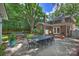 Well-maintained backyard with lush lawn, dining area, brick patio, and mature trees at 726 E Kingston Ave, Charlotte, NC 28203