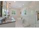 Bright bathroom with a soaking tub, glass shower, double vanity, and stylish geometric tile floor at 726 E Kingston Ave, Charlotte, NC 28203