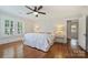 Well-lit bedroom featuring hardwood floors, neutral walls, shuttered windows, and a ceiling fan at 726 E Kingston Ave, Charlotte, NC 28203