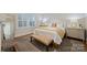 Comfortable bedroom with a bench, a window with blinds, and neutral colors at 726 E Kingston Ave, Charlotte, NC 28203