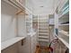 Spacious walk-in closet with built-in shelves, drawers, and multiple rods for optimal organization at 726 E Kingston Ave, Charlotte, NC 28203