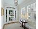 Bright foyer with hardwood floors, white trim, sidelights, and traditional furnishings with ample sunlight at 726 E Kingston Ave, Charlotte, NC 28203