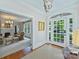 Inviting foyer featuring hardwood floors, an elegant chandelier, and arched doorway to the living room at 726 E Kingston Ave, Charlotte, NC 28203