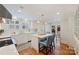 Bright kitchen featuring white cabinets, hardwood floors, stainless appliances, an island, and a backyard view at 726 E Kingston Ave, Charlotte, NC 28203