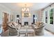 Elegant living room with a white fireplace, matching sofas, soft lighting, and neutral decor at 726 E Kingston Ave, Charlotte, NC 28203