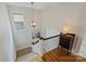 Bright landing featuring wood floors, a staircase with carpet runner and a decorative pendant light at 726 E Kingston Ave, Charlotte, NC 28203
