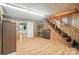 Finished basement space with wood-paneled walls, laminate flooring, and a staircase at 900 Nance St, Kannapolis, NC 28083