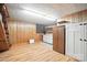 Finished basement featuring wood-paneled walls, laminate floors, and utility cabinets at 900 Nance St, Kannapolis, NC 28083