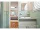 Bathroom with tile accents featuring a classic sink and a doorway view into the bedroom at 900 Nance St, Kannapolis, NC 28083