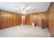 Bedroom with carpeted floors, wood paneling, a ceiling fan, and baseboard heating at 900 Nance St, Kannapolis, NC 28083