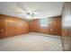 Bedroom features carpeted floors, wood paneling, a window, and baseboard heating at 900 Nance St, Kannapolis, NC 28083