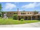 Rear exterior featuring a brick facade, covered patio, well-maintained lawn, and mature landscaping at 900 Nance St, Kannapolis, NC 28083