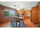 Cozy kitchen and dining area features classic wood paneling and ample natural light from the window view at 900 Nance St, Kannapolis, NC 28083