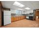 An eat-in kitchen offers ample counter space, white cabinets, wood floors, and essential appliances at 900 Nance St, Kannapolis, NC 28083