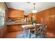 Eat-in kitchen with wood cabinets, stone countertops, and a table with seating for a casual dining experience at 900 Nance St, Kannapolis, NC 28083
