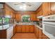 Efficient kitchen layout featuring wood cabinetry, modern appliances, and countertops for culinary enthusiasts at 900 Nance St, Kannapolis, NC 28083