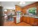 Well-lit kitchen with granite counters, wood cabinets, and a dining area provides a functional space at 900 Nance St, Kannapolis, NC 28083