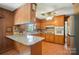 Well-lit kitchen featuring wood cabinets, granite countertops, and stainless steel appliances at 900 Nance St, Kannapolis, NC 28083