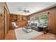 Cozy living room with wood paneled walls, a built-in bookcase, and ample natural light at 900 Nance St, Kannapolis, NC 28083