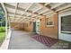 Inviting covered patio area with brick accents, perfect for outdoor relaxation and entertaining with an access door to the home at 900 Nance St, Kannapolis, NC 28083
