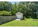 Exterior view of shed in backyard with wooden fence and lush greenery at 900 Nance St, Kannapolis, NC 28083