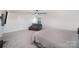 This bedroom has plush carpet, a ceiling fan, and natural light at 1010 Harry Ct, Albemarle, NC 28001