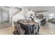 A cozy dining area features a wooden table with six chairs and modern staircase at 1010 Harry Ct, Albemarle, NC 28001