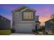 Charming two-story home with a two car garage on a well maintained lawn at dusk at 1010 Harry Ct, Albemarle, NC 28001