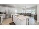 Open kitchen boasts stainless appliances, granite counters, large island, and flows into the bright living room at 1010 Harry Ct, Albemarle, NC 28001