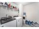 Functional laundry room equipped with modern washer, dryer, and ample shelving at 1010 Harry Ct, Albemarle, NC 28001