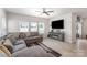 Comfortable living room featuring a large gray sectional sofa, entertainment center and wood floors at 1010 Harry Ct, Albemarle, NC 28001