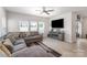 Comfortable living room featuring a large gray sectional sofa, entertainment center and wood floors at 1010 Harry Ct, Albemarle, NC 28001