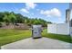 Backyard area showcasing an outdoor grill with a concrete patio, lush green grass and privacy fence at 11246 Bartrams Way, Charlotte, NC 28278
