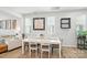 Dining area with wood floors, a modern light fixture, and a view of the backyard at 11246 Bartrams Way, Charlotte, NC 28278