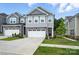 Charming two-story home with stone accents, gray siding, and a well-manicured lawn at 11246 Bartrams Way, Charlotte, NC 28278