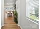 Bright hallway with wood floors, leading to a dining area with plenty of natural light at 11246 Bartrams Way, Charlotte, NC 28278