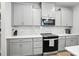Modern kitchen with sleek countertops, stainless steel appliances, and light gray cabinetry at 11246 Bartrams Way, Charlotte, NC 28278