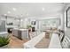 Open-concept kitchen and living area, with modern appliances, a fireplace, and ample seating at 11246 Bartrams Way, Charlotte, NC 28278