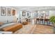 Stylish living room seamlessly connects to dining area and kitchen with hardwood floors and neutral tones at 11246 Bartrams Way, Charlotte, NC 28278