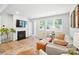 Cozy living room with a fireplace, a large TV, and lots of natural light at 11246 Bartrams Way, Charlotte, NC 28278