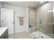 Contemporary shower with glass door, built-in bench, and sleek tile design in modern bathroom at 11246 Bartrams Way, Charlotte, NC 28278