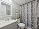Cozy bathroom featuring a single sink vanity, and a shower with patterned shower curtain at 1140 Randall Ct, Concord, NC 28025