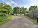 Exterior view showcasing the long driveway leading to the charming home at 1140 Randall Ct, Concord, NC 28025