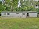 Charming one-story home with a well-manicured lawn and lovely landscaping at 1140 Randall Ct, Concord, NC 28025